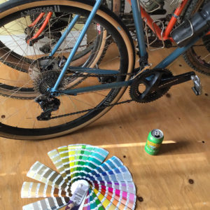 Pantone color book fanned out in front of bikes
