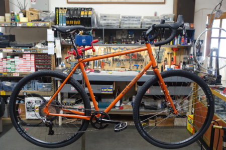 orange black mountain cycles mcd bike in work stand