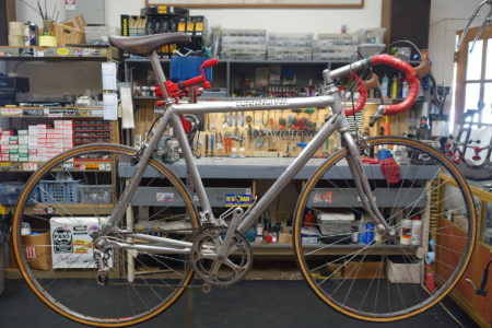 vintage Cunningham road bike in bike shop work stand