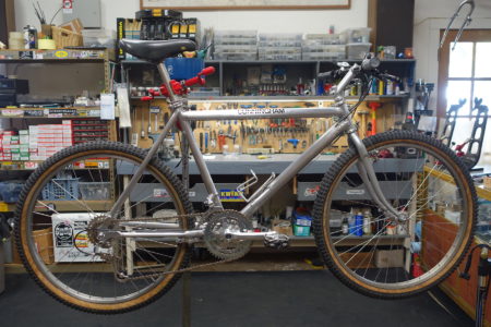 Vintage Cunningham mountain bike in bike shop work stand